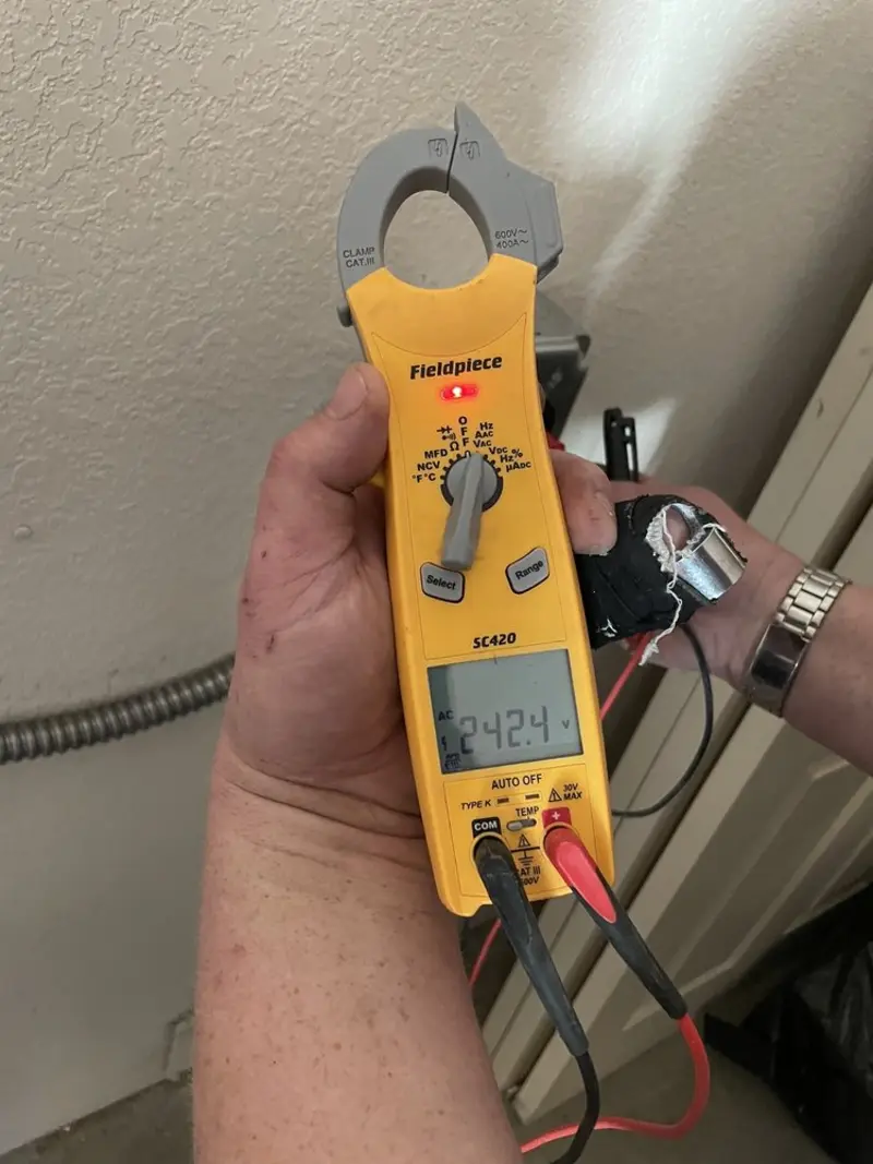 Voltage testing with clamp meter during Whole House Surge Protector in Chesapeake Beach